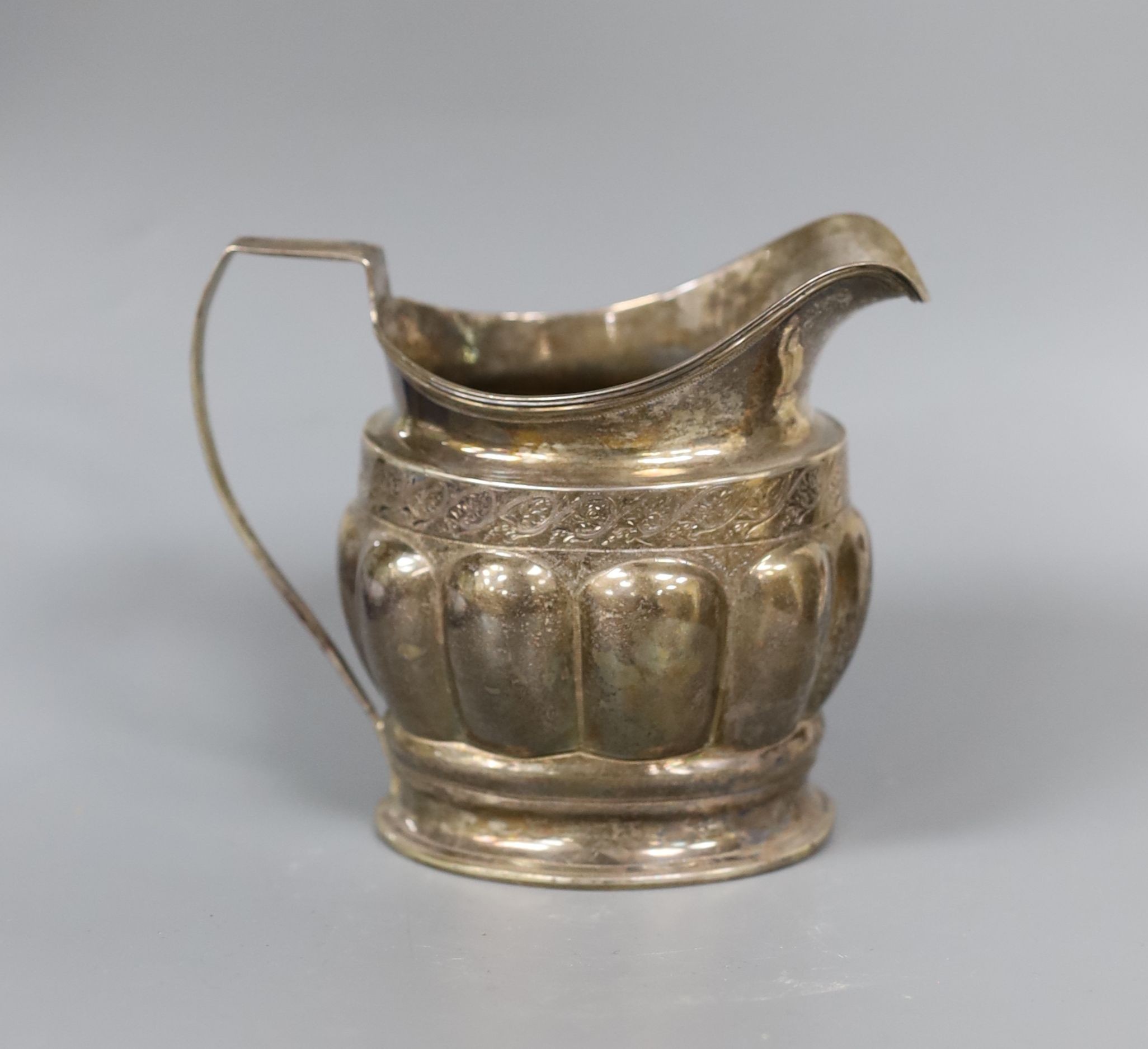 A George III silver cream jug, with lobed body, Soloman Hougham, London, 1799, 10.3cm, 159 grams.